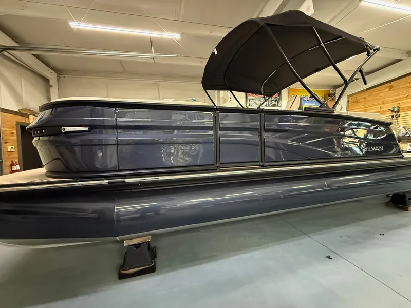 Slide: The Image of 2025 Sylvan G-3 CLZ DH pontoon boat with black canopy in showroom. - 0