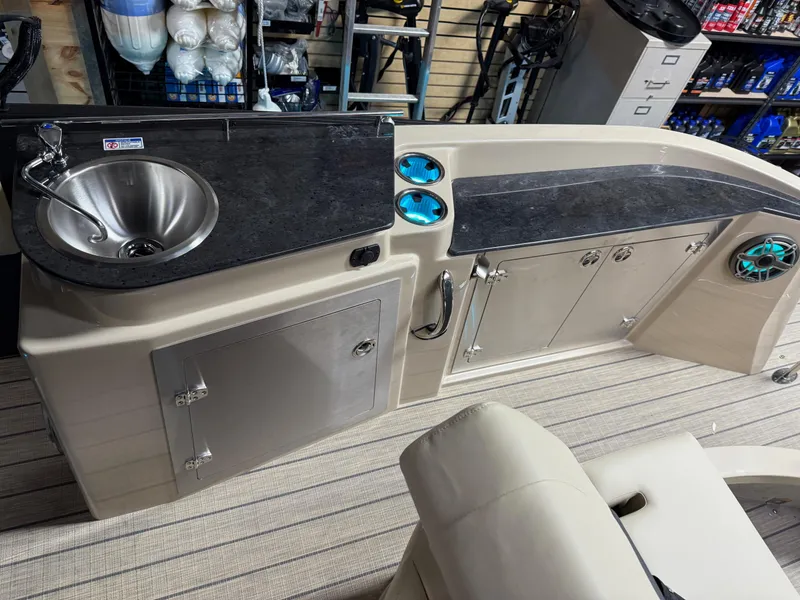 Slide: The Image of Modern Sylvan G-3 CLZ DH 2025 boat interior with sink and storage cabinets. - 10