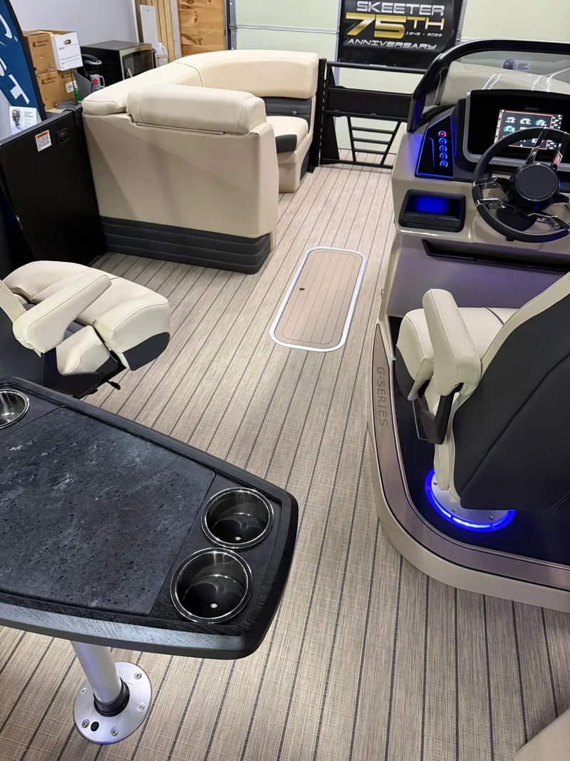 Slide: The Image of 2025 Sylvan G-3 CLZ DH boat interior with modern seating and illuminated dashboard. - 14