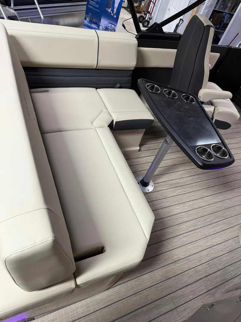 Slide: The Image of 2025 Sylvan G-3 CLZ DH boat interior with beige seating and sleek black table. - 15