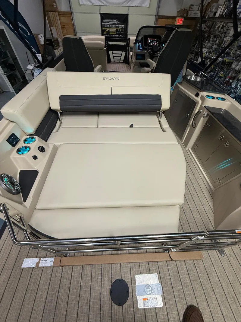Slide: The Image of 2025 Sylvan G-3 CLZ DH boat interior with beige seating and modern controls. - 18