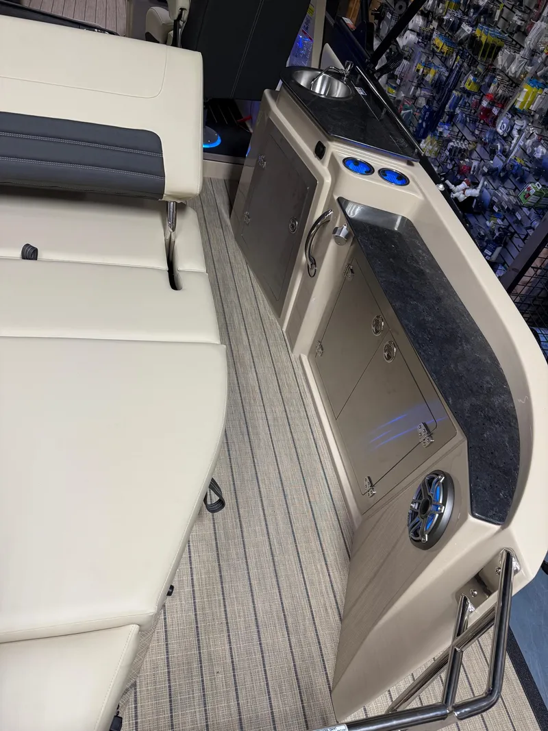 Slide: The Image of 2025 Sylvan G-3 CLZ DH boat interior with seating and kitchenette area. - 19