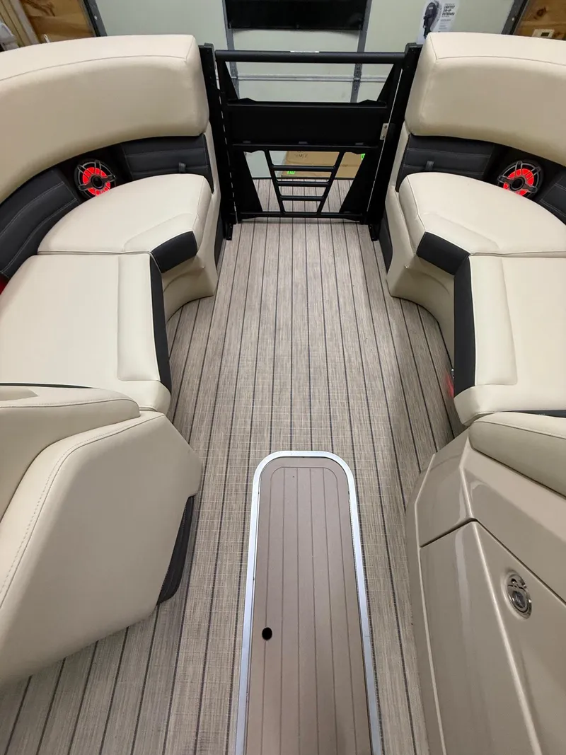 Slide: The Image of 2025 Sylvan G-3 CLZ DH boat interior with beige seating and wood-style flooring. - 22