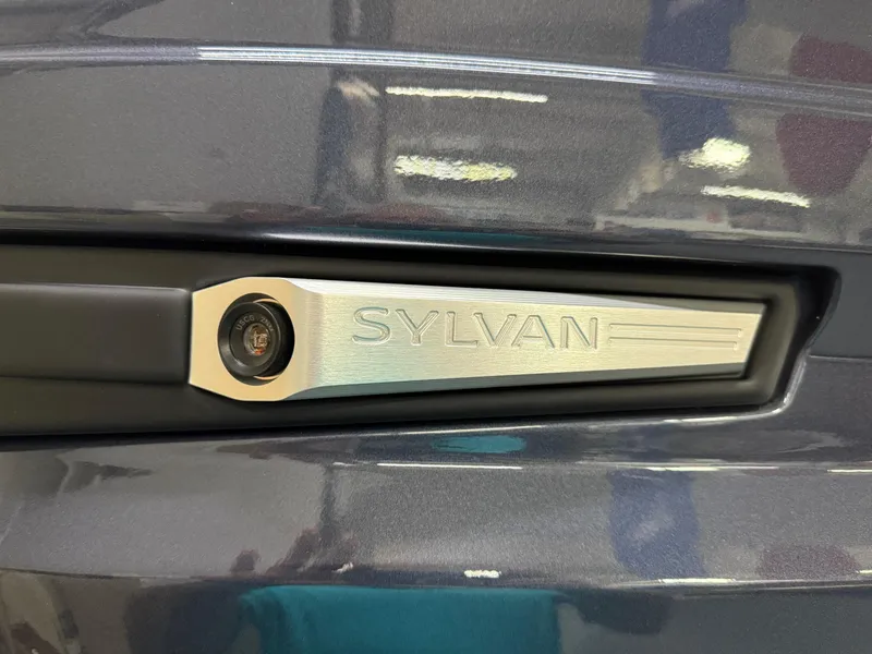 Slide: The Image of Close-up of 2025 Sylvan G-3 CLZ DH logo on a sleek metallic surface. - 34