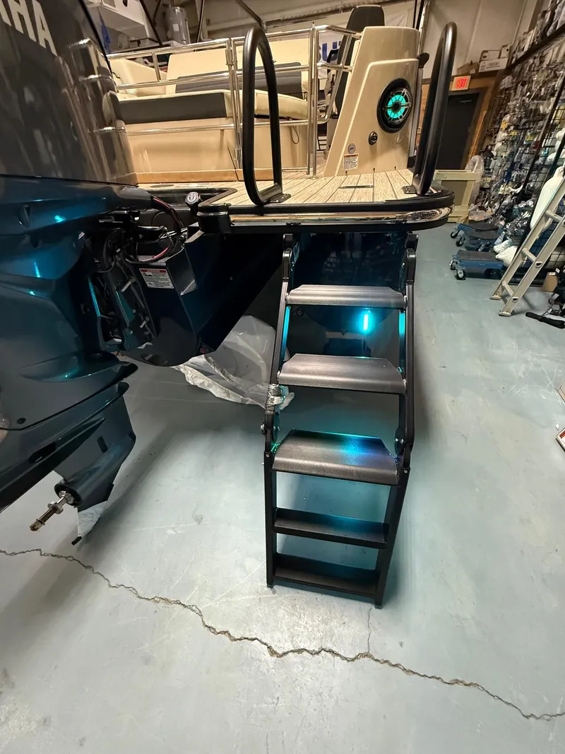 Slide: The Image of 2025 Sylvan G-3 CLZ DH boat with illuminated boarding ladder in a showroom. - 35