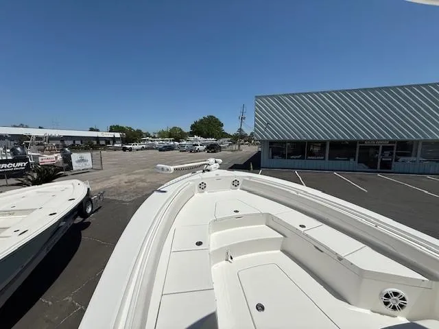 Slide: The Image of 2024 Regulator 26XO boat displayed outdoors at a dealership. - 11