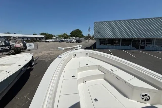 Slide: The Image of 2024 Regulator 26XO boat displayed in a dealership parking lot under clear blue skies. - 13