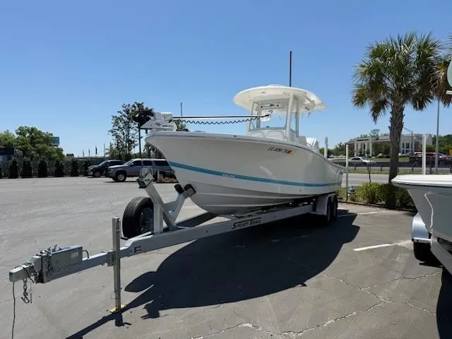 Slide: The Image of 2024 Regulator 26XO boat on trailer in sunny parking lot. - 3