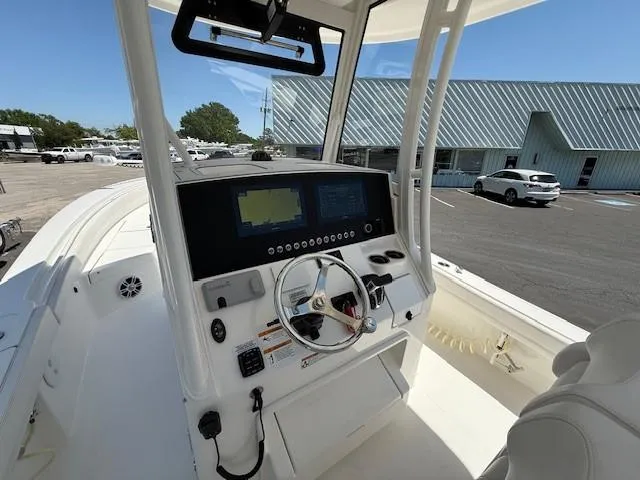 Slide: The Image of 2024 Regulator 26XO boat dashboard with steering wheel and navigation screens. - 6