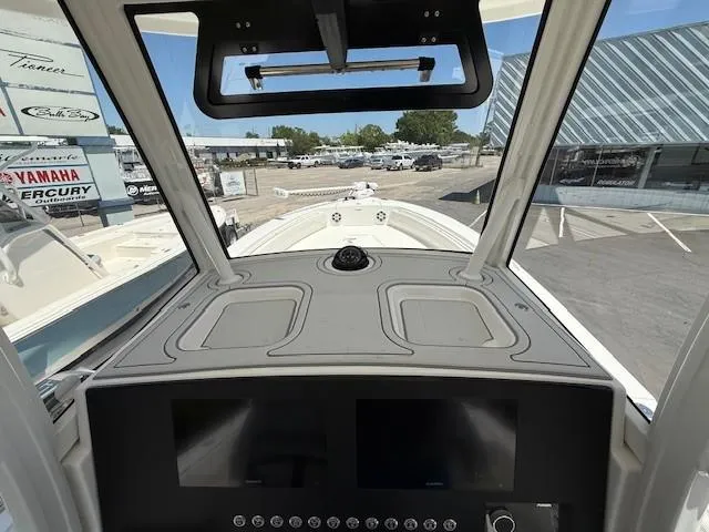 Slide: The Image of 2024 Regulator 26XO boat dashboard with modern controls and navigation equipment. - 7