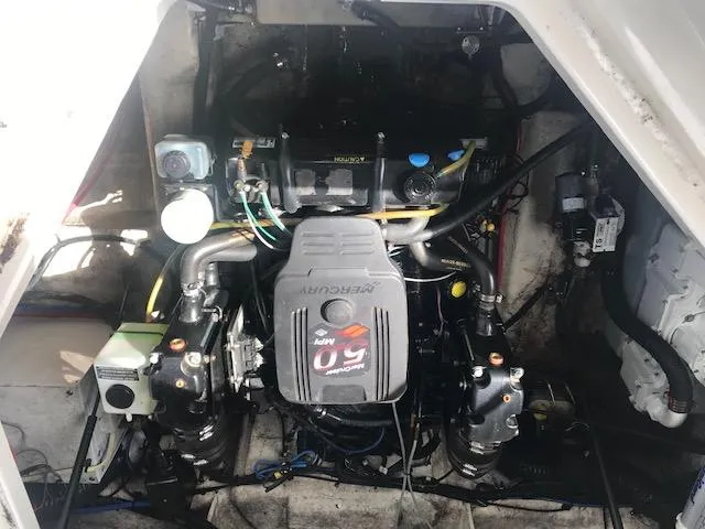 Slide: The Image of Engine compartment of a 2006 Sea Ray Sundancer boat, showcasing the engine and components. - 12