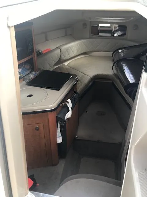 Slide: The Image of 2006 Sea Ray Sundancer cabin interior with seating and kitchenette. - 13