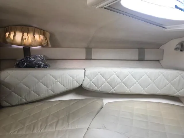Slide: The Image of 2006 Sea Ray Sundancer cabin interior with quilted seating and soft lighting. - 17
