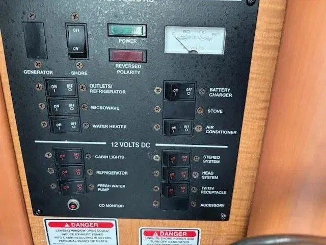 Slide: The Image of Control panel of a 2006 Sea Ray Sundancer boat with various switches and warnings. - 20