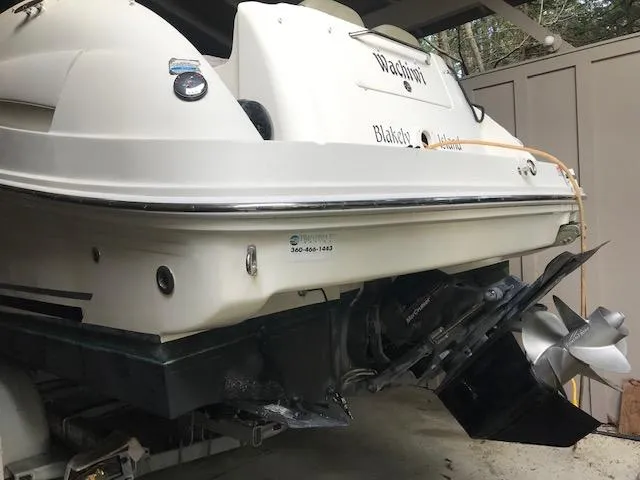 Slide: The Image of 2006 Sea Ray Sundancer boat with visible propeller and hull, parked in a covered area. - 3