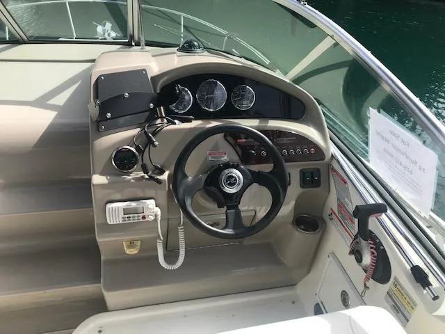 Slide: The Image of 2006 Sea Ray Sundancer helm with steering wheel, gauges, and controls. - 8