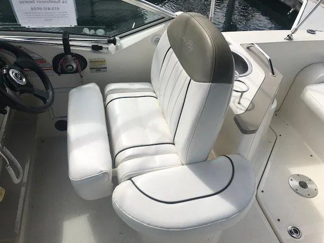 Slide: The Image of Captain's seat on a 2006 Sea Ray Sundancer boat, featuring white leather upholstery. - 9