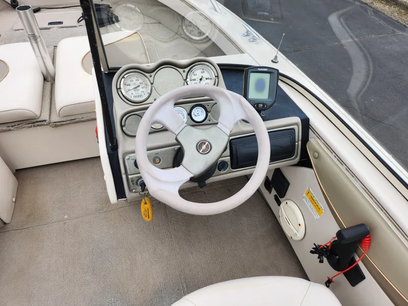 Slide: The Image of 2000 Crestliner 1850 Sportfish boat dashboard with steering wheel and gauges. - 13