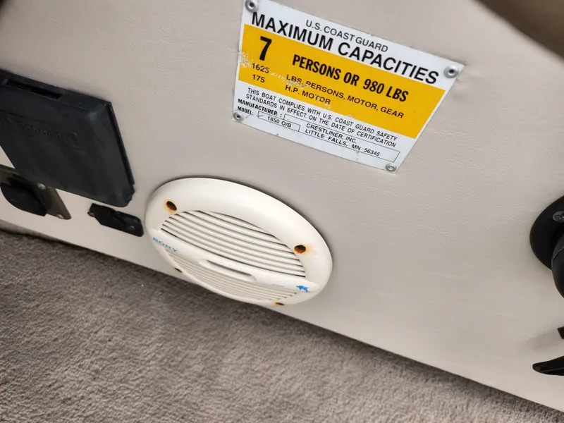 Slide: The Image of Crestliner 1850 Sportfish 2000 boat capacity label, showing 7 persons or 980 lbs limit. - 15