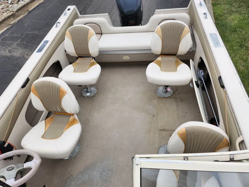 Slide: The Image of 2000 Crestliner 1850 Sportfish boat interior with four swivel seats and beige upholstery. - 20