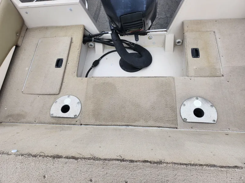 Slide: The Image of Crestliner 1850 Sportfish 2000 boat interior with storage compartments and motor mount. - 23