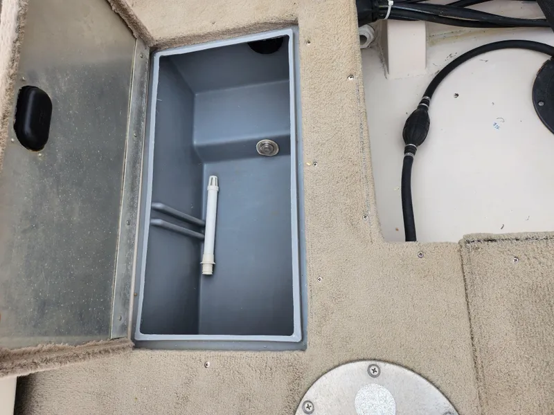 Slide: The Image of Open storage compartment on 2000 Crestliner 1850 Sportfish boat deck. - 24