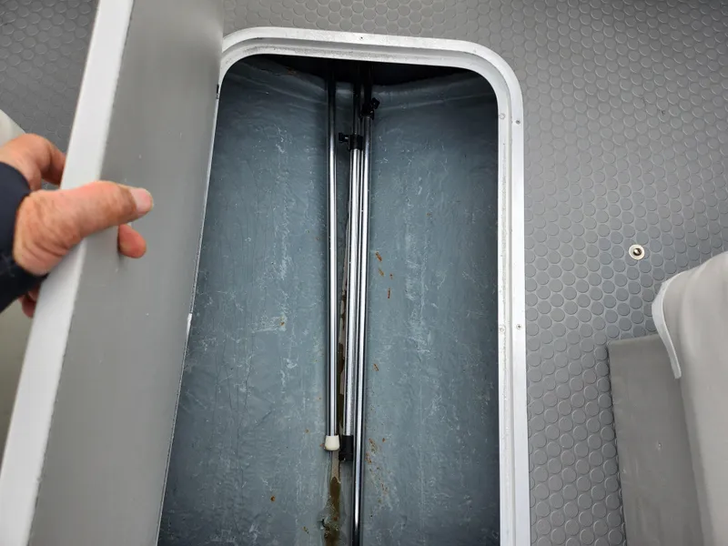 Slide: The Image of Storage compartment in a 2007 Bayliner Discovery 195 boat, with open hatch and visible interior. - 12