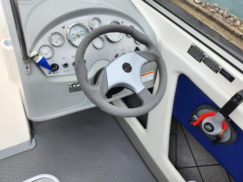 Slide: The Image of 2007 Bayliner Discovery 195 dashboard with steering wheel and instrument panel. - 14