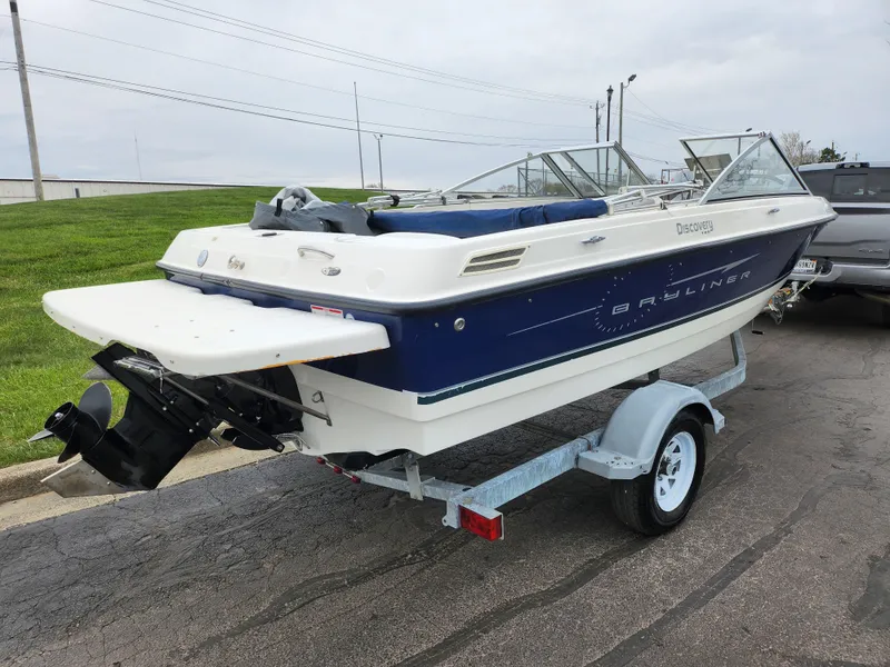 Slide: The Image of 2007 Bayliner Discovery 195 boat on trailer, parked outdoors. - 3