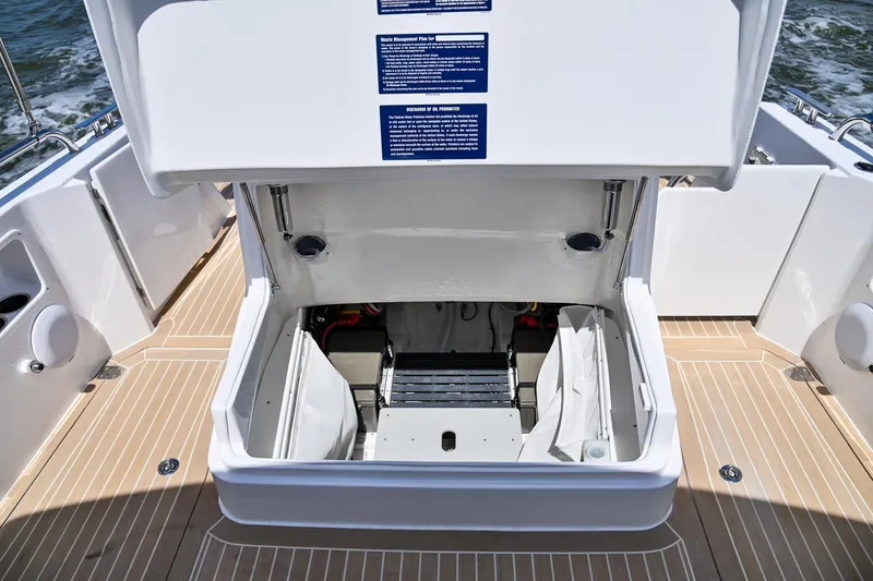 Slide: The Image of Open storage compartment on 2025 MJM 35 boat deck. - 19
