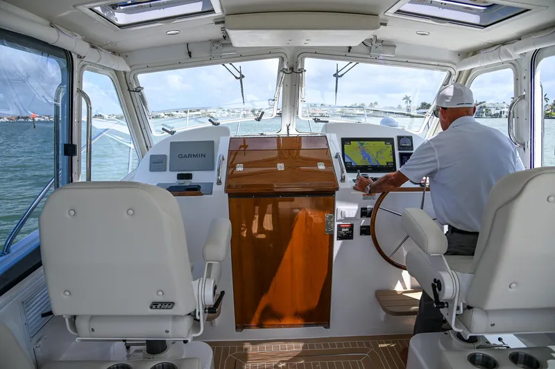 Slide: The Image of Interior view of 2025 MJM 35 boat cockpit with navigation equipment and captain steering. - 26