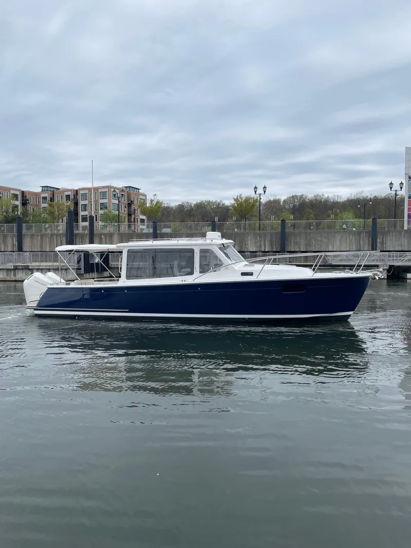 Slide: The Image of 2025 MJM 35 boat on calm water near urban waterfront. - 8