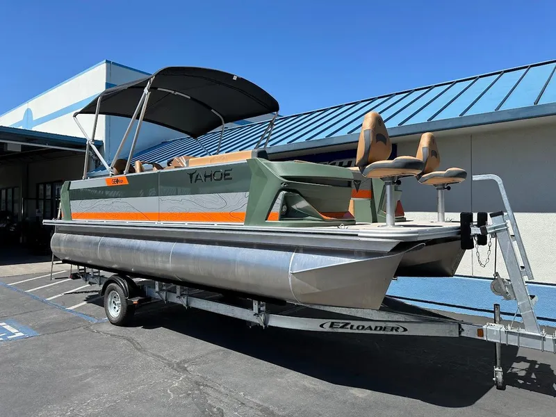 Slide: The Image of 2025 Tahoe Pontoon Geofish RF on trailer, featuring sleek design and canopy. - 1