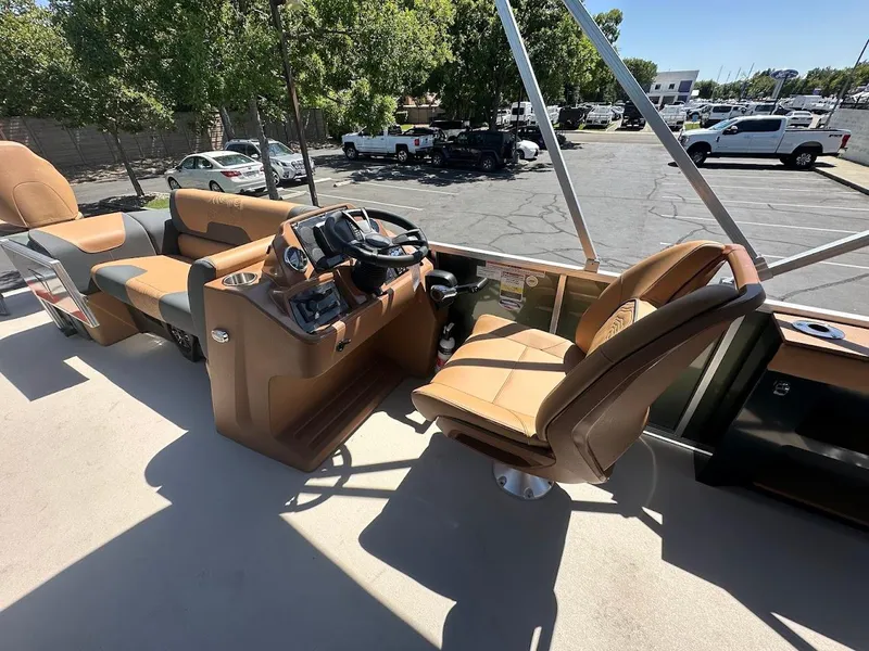 Slide: The Image of 2025 Tahoe Pontoon Geofish RF interior with tan seating and steering console. - 19