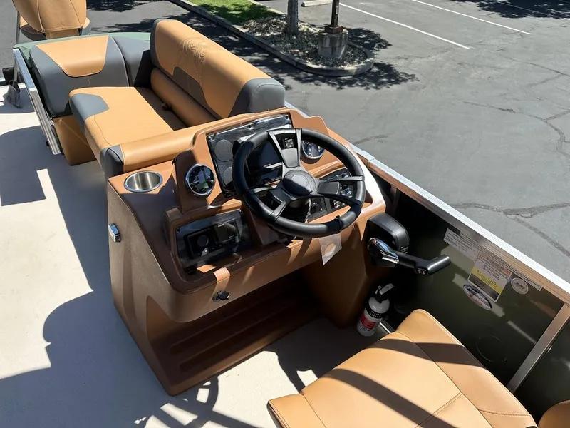 Slide: The Image of 2025 Tahoe Pontoon Geofish RF boat interior with steering wheel and seating. - 20