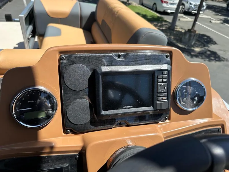 Slide: The Image of 2025 Tahoe Pontoon Geofish RF dashboard with navigation system and gauges. - 23