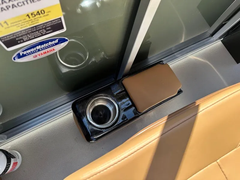 Slide: The Image of 2025 Tahoe Pontoon Geofish RF interior with cup holder and tan seating. - 26