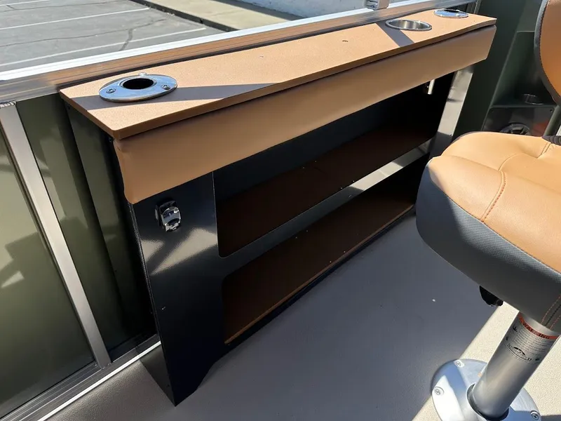 Slide: The Image of 2025 Tahoe Pontoon Geofish RF interior with storage shelves and cup holders. - 28