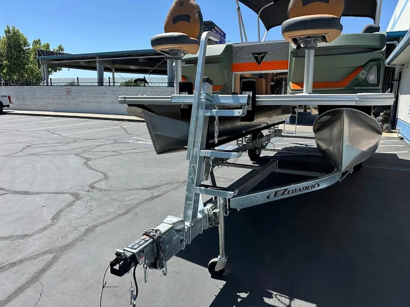 Slide: The Image of 2025 Tahoe Pontoon Geofish RF on trailer, parked outdoors. - 3