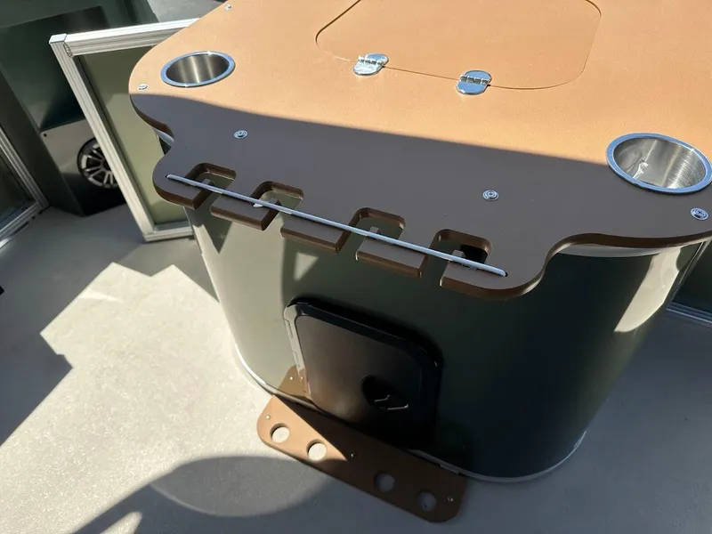 Slide: The Image of 2025 Tahoe Pontoon Geofish RF console with cup holders and storage compartment. - 30