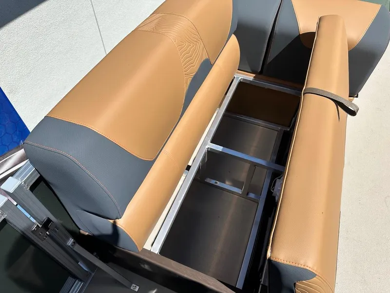Slide: The Image of 2025 Tahoe Pontoon Geofish RF seating with storage compartment, featuring tan and gray upholstery. - 37