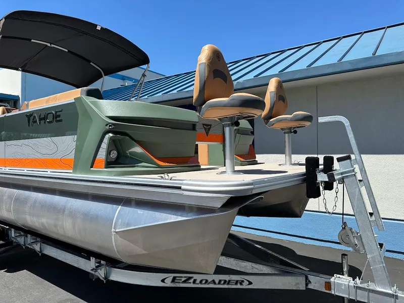 Slide: The Image of 2025 Tahoe Pontoon Geofish RF on EZ Loader trailer, featuring dual fishing seats. - 4