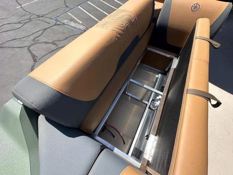 Slide: The Image of 2025 Tahoe Pontoon Geofish RF seating with storage compartment, tan and gray upholstery. - 42