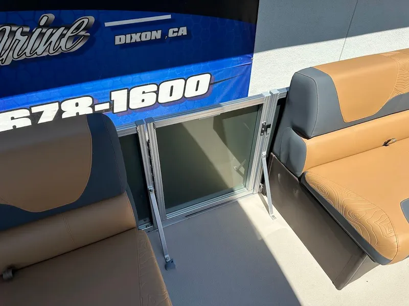 Slide: The Image of 2025 Tahoe Pontoon Geofish RF interior with tan seating and blue signage. - 45