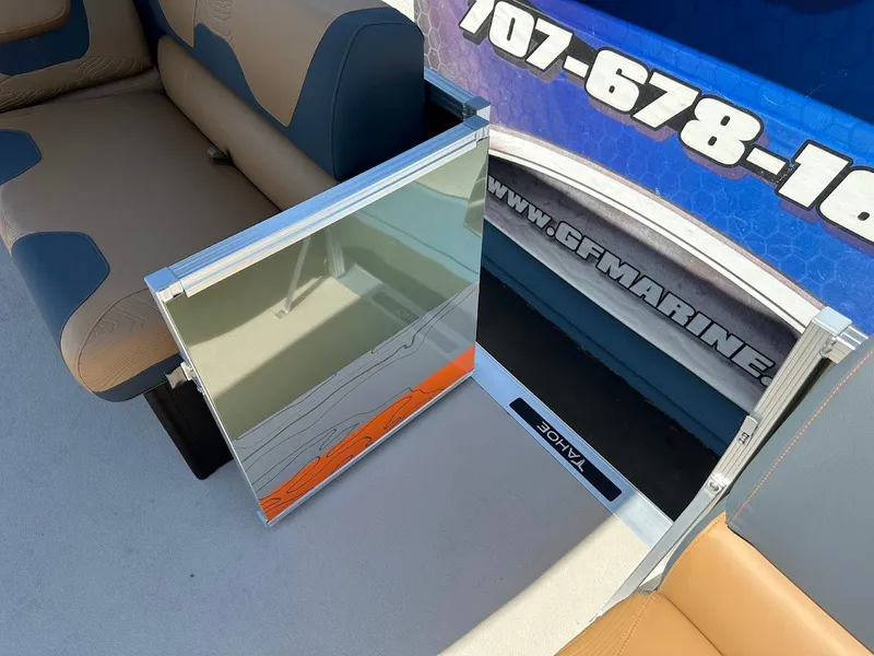 Slide: The Image of 2025 Tahoe Pontoon Geofish RF interior with seating and storage compartment. - 46