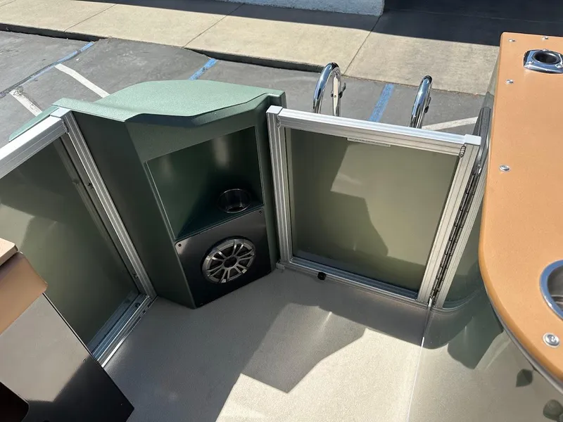 Slide: The Image of 2025 Tahoe Pontoon Geofish RF interior with speaker and storage compartment. - 49
