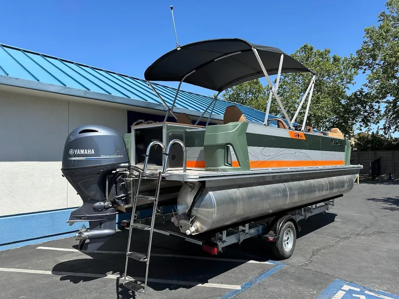 Slide: The Image of 2025 Tahoe Pontoon Geofish RF with Yamaha engine on trailer, parked outdoors. - 7