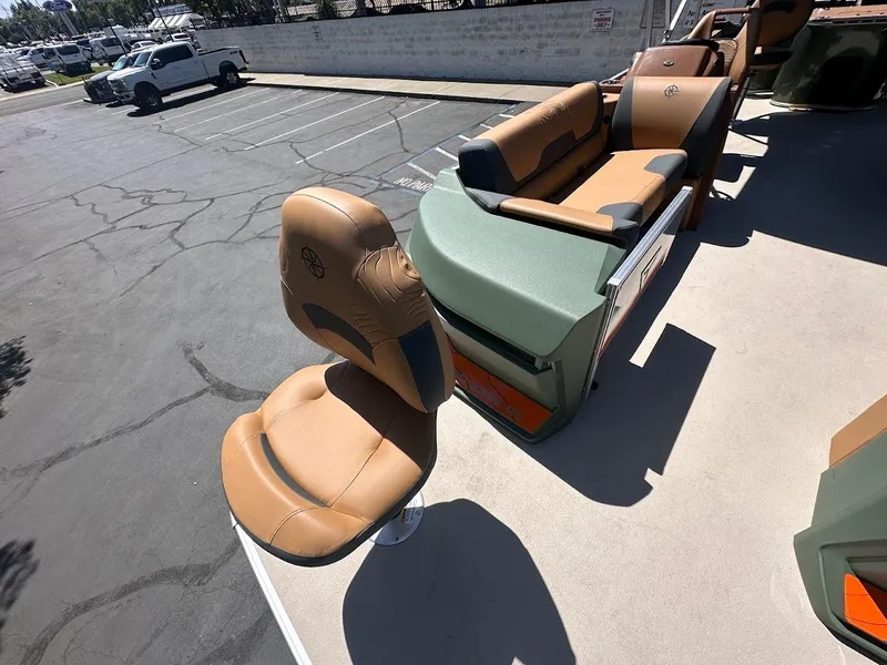 Slide: The Image of 2025 Tahoe Pontoon Geofish RF with tan seating in a parking lot. - 9