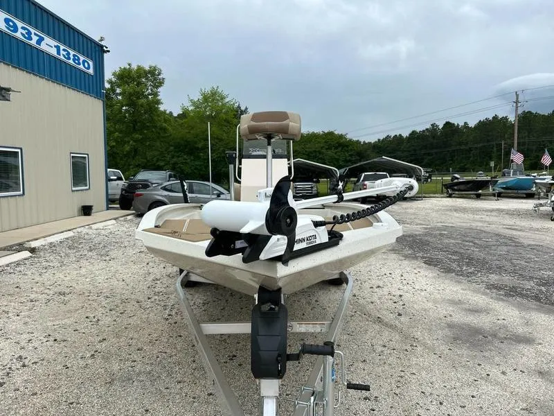 Slide: The Image of 2025 Xpress H210B boat on trailer, parked outside dealership, overcast sky. - 2