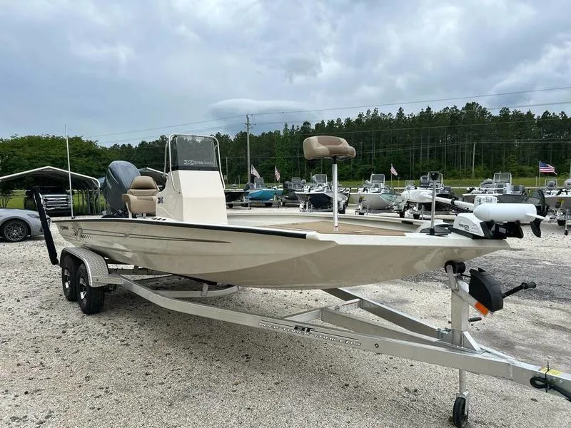 Slide: The Image of 2025 Xpress H210B boat on trailer in outdoor dealership lot. - 3